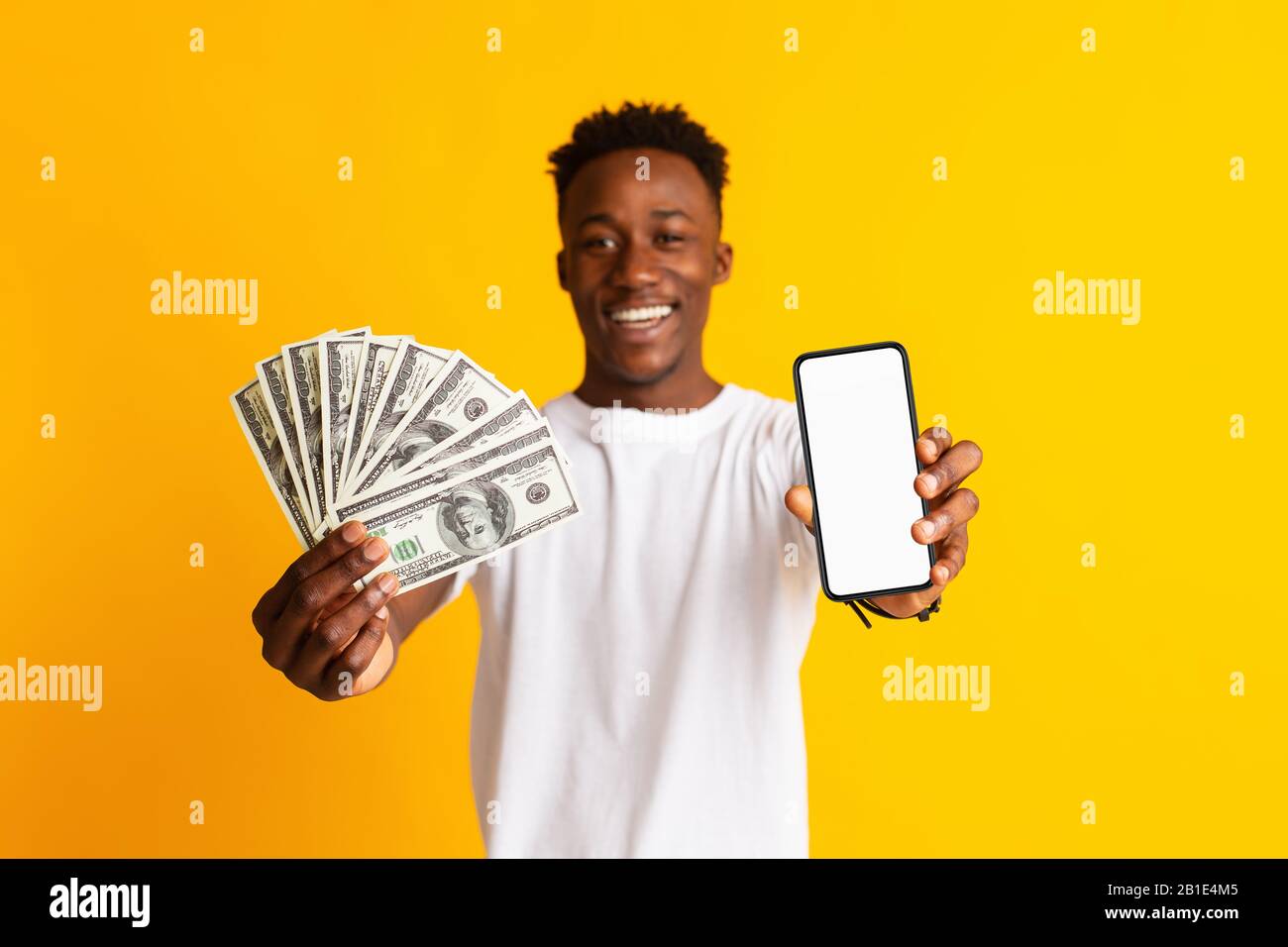 Excited african man holding lots of money in dollar currency Stock ...