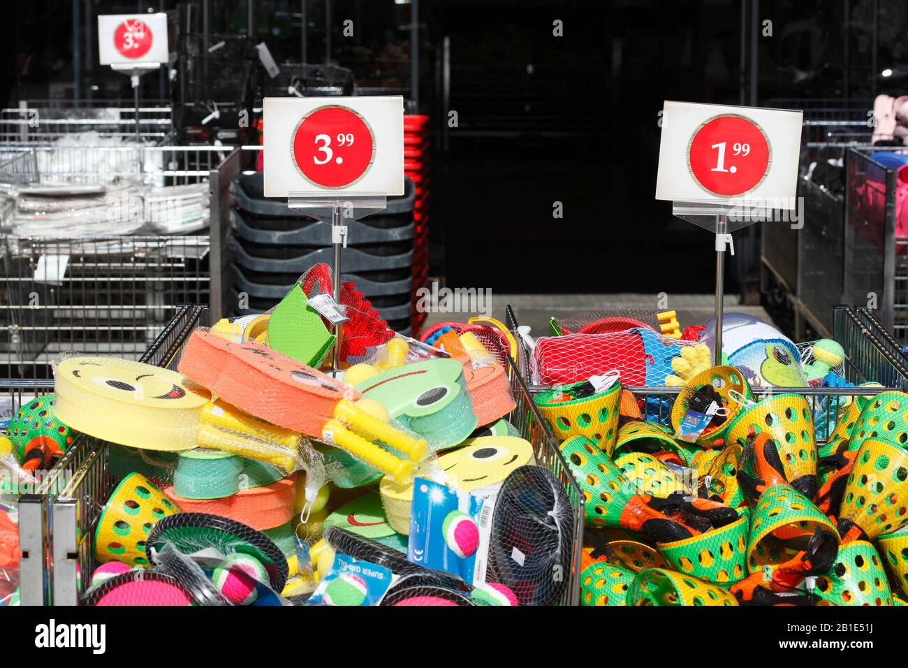 Colorful plastic toys with price tags in front of a shopping mall, Germany Stock Photo