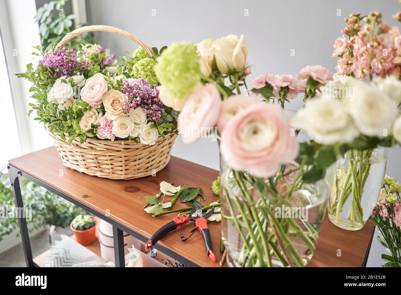Education in the school of floristry. Master class on making bouquets.  Summer bouquet in a wicker basket.. Learning flower arranging, making  beautiful Stock Photo - Alamy