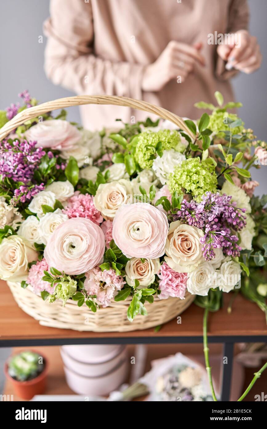 Woman florist creating beautiful bouquet in flower shop. Work in flower shop. Flowers delivery
