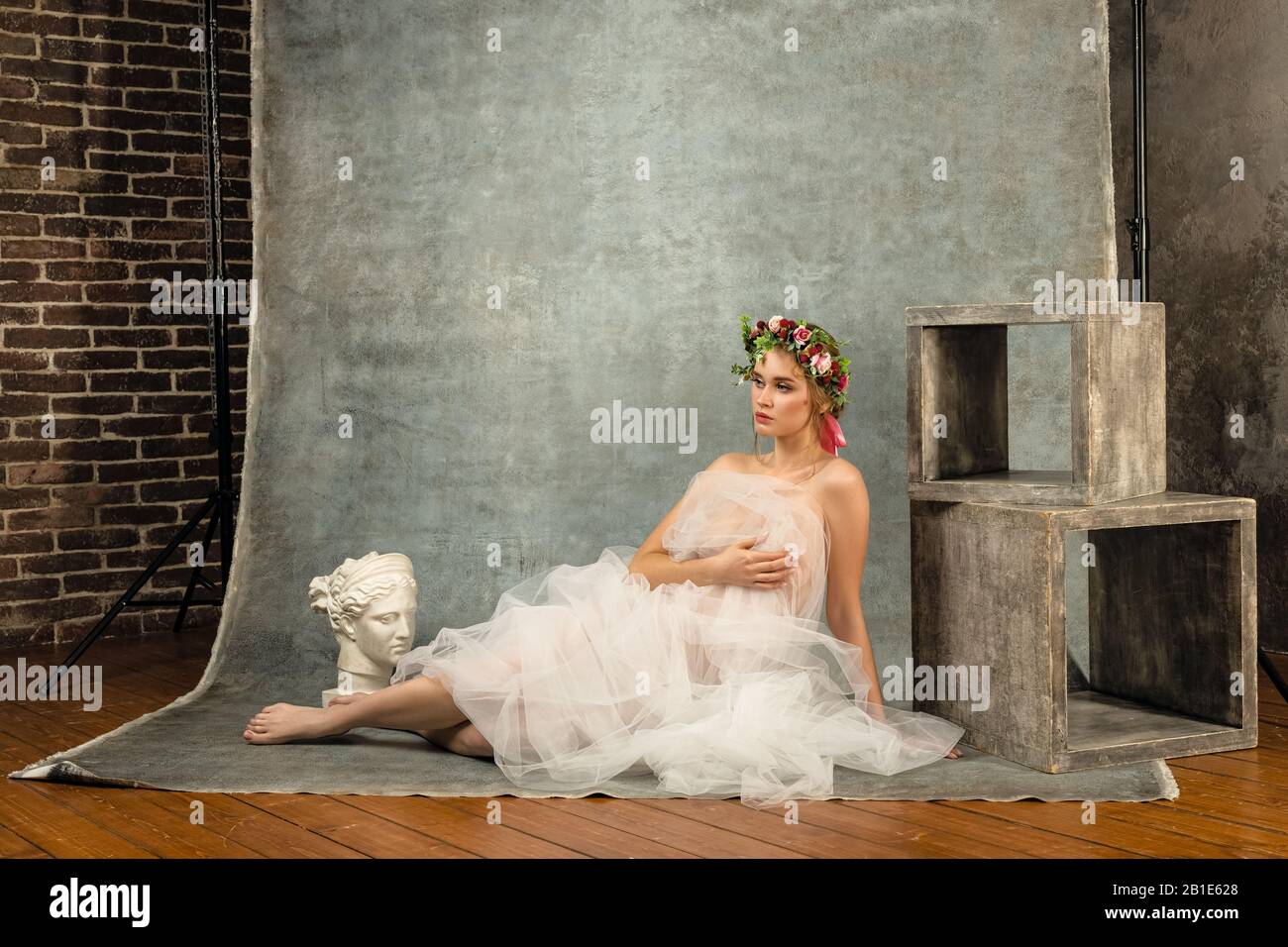 Model posing for a photograph during a photo shoot Stock Photo - Alamy