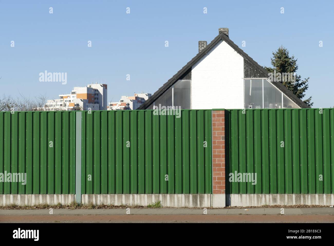 Noise barrier on a street with residential buildings, Bremen, Germany Stock Photo
