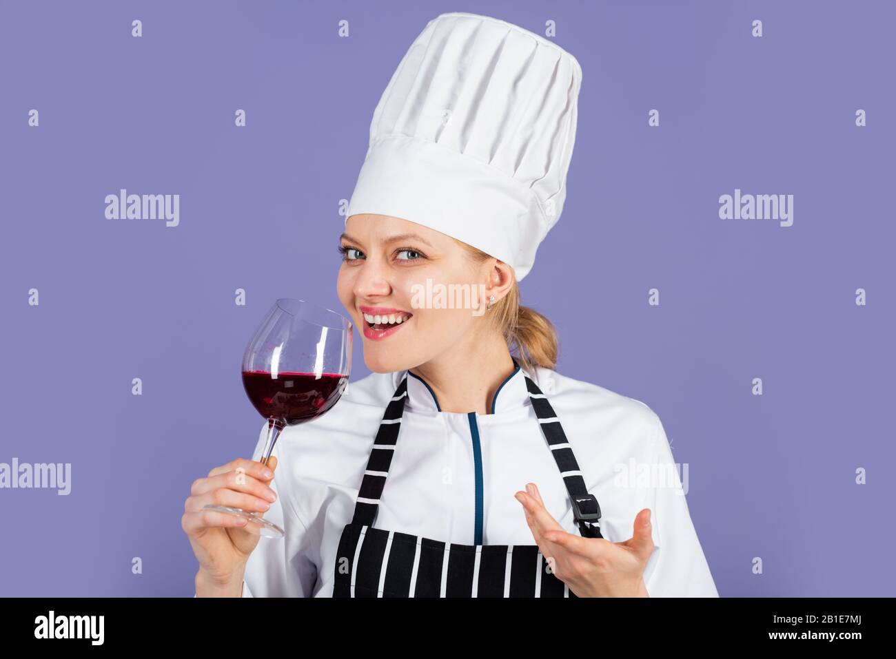 sweet and soft. sommelier with red cabernet or merlot. Restaurant beverage concept. cook degusting wine. woman hold wineglass in restaurant. perfect burgundy beverage. cook drink alcohol. Stock Photo