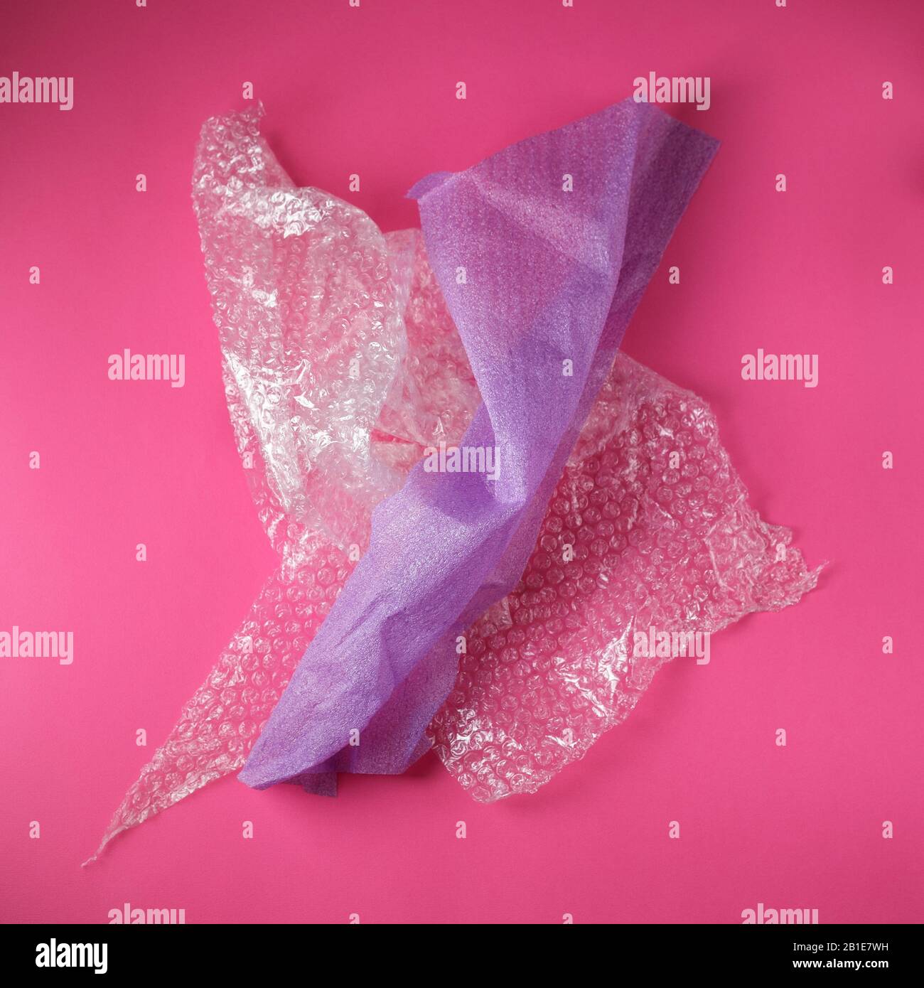 Plastic Bubble and Foam Cushioning Wrap on pink background Stock Photo