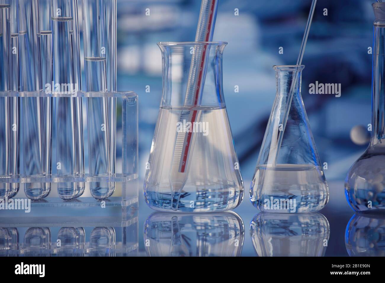 Science laboratory. Beakers, testtubes and microscope on glass table