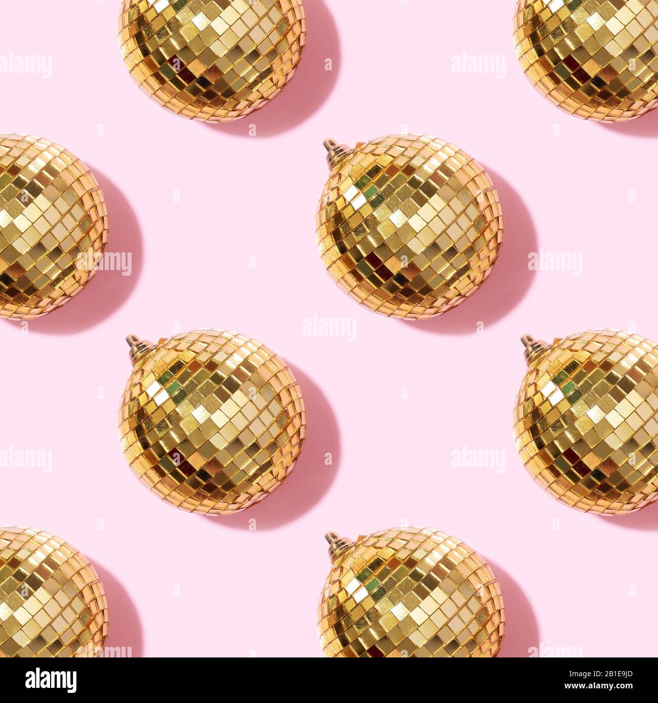 Creative Christmas pattern. Shiny gold disco balls over pink background.  Flat lay, top view. New year baubles, star sparkles. Party time. Cristmas  greeting card Stock Photo - Alamy