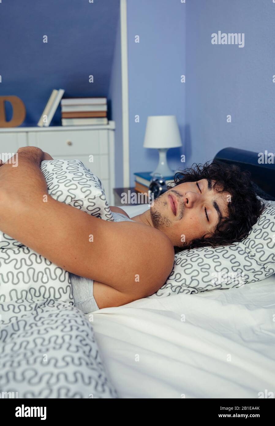 Man sleeping in bed at home Stock Photo