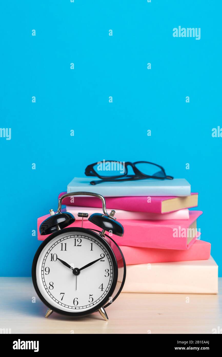 Back to school background with books and alarm clock Stock Photo - Alamy