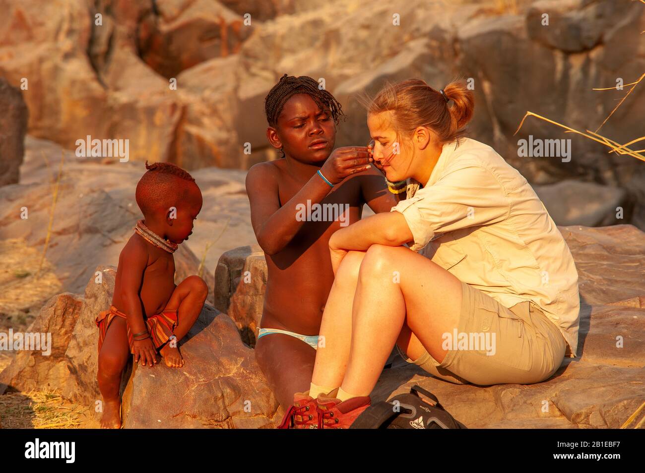 European woman socializing with kids of the himba tribe at Epupa Falls,  Kunene Region, Namibia Stock Photo - Alamy