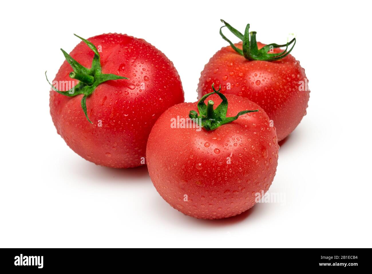 Three ripe tomatoes isolated on white background Stock Photo - Alamy