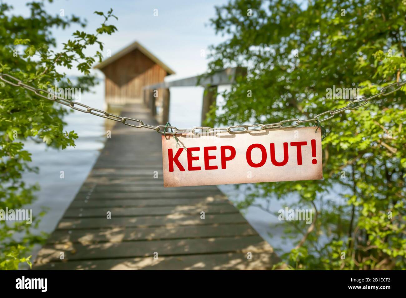 Blocked private mole at a lake with the sign KEEP OUT Stock Photo