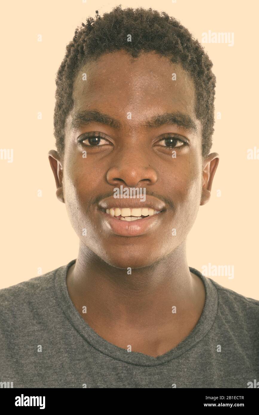 Face of young happy black African teenage boy smiling from Botswana Stock Photo