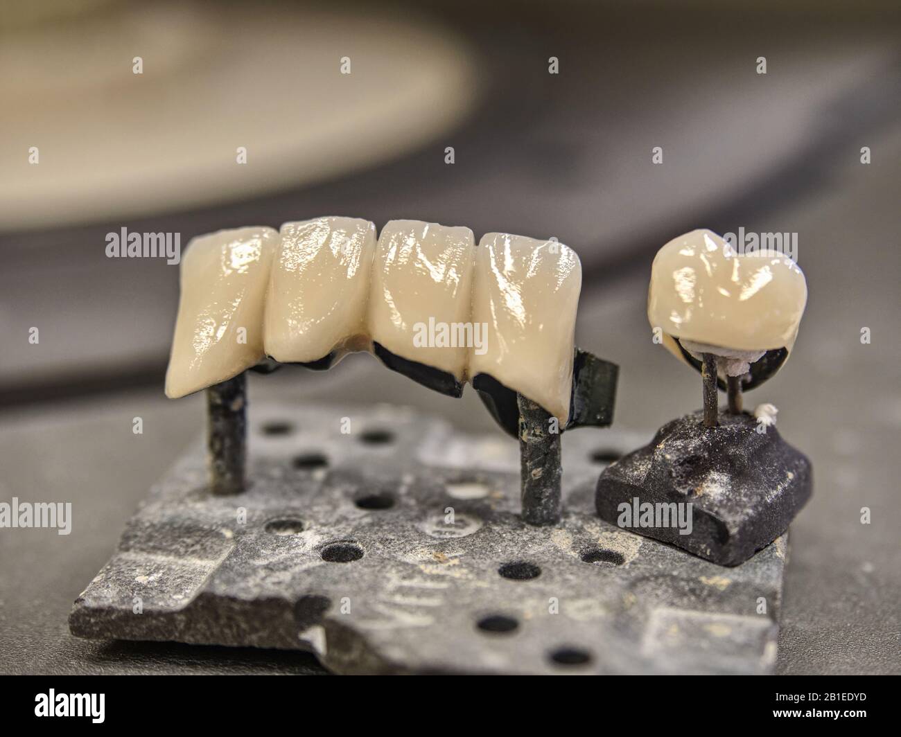 Laboratory furnace for ceramic tooth crowns and metal pins close-up macro. Orthopedic dentistry restoration decayed teeth Stock Photo