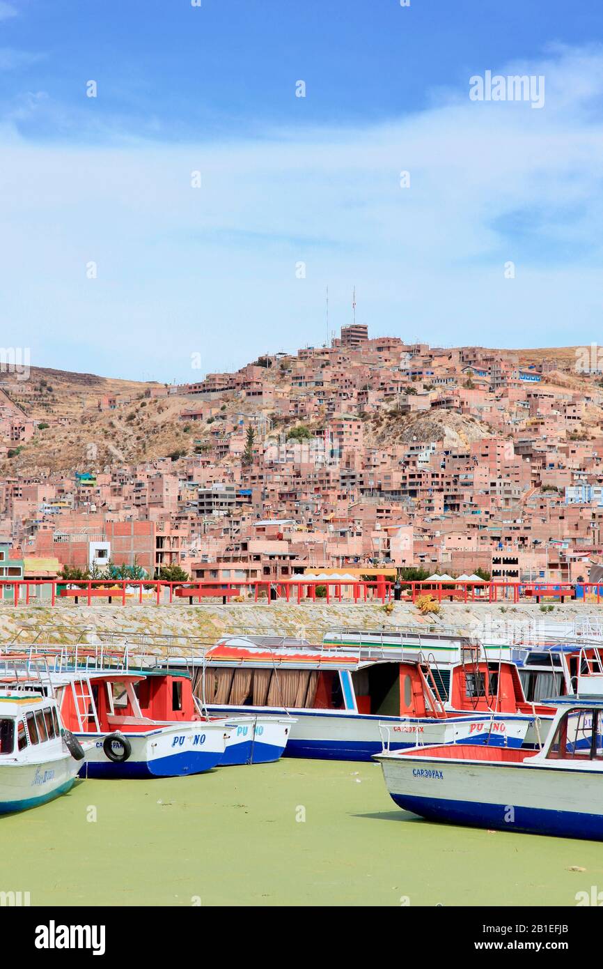 Boats on Lake Titicaca and green algae due to pollution, Puno, Peru. Stock Photo