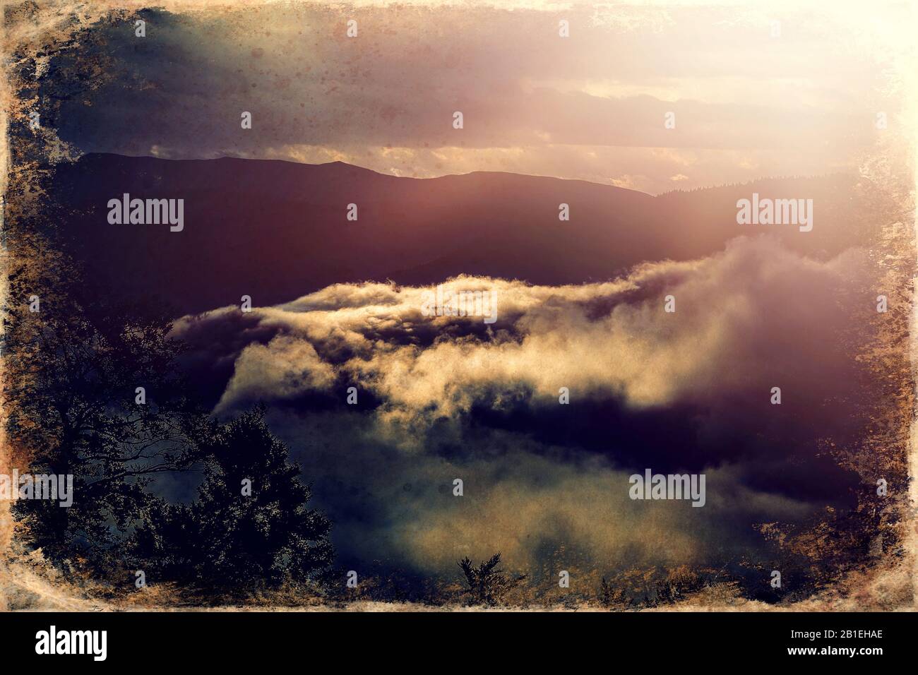 Beautiful morning mountains in fog and old photo effect Stock Photo - Alamy