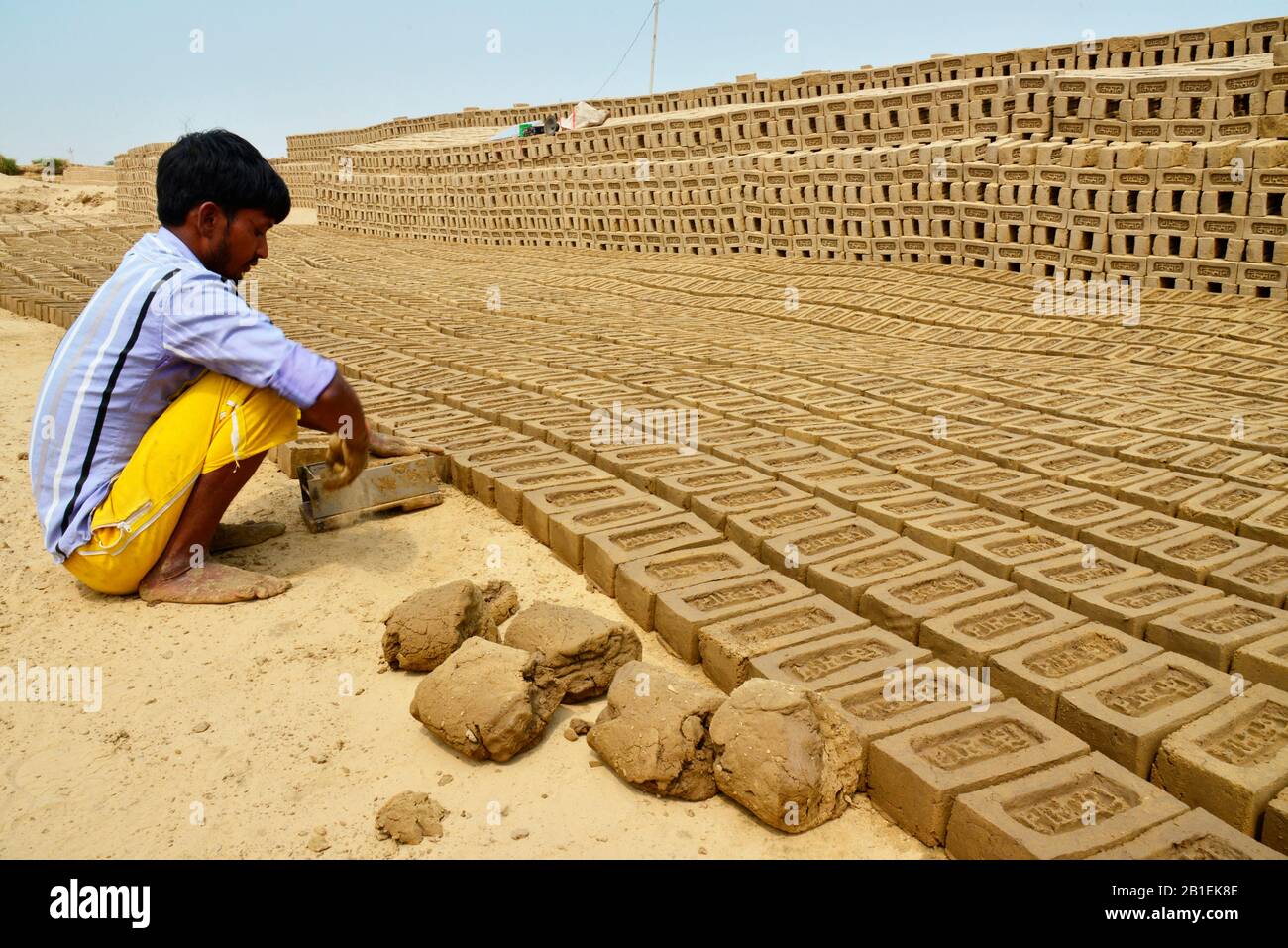Brick factory where families are making bricks with clay before drying