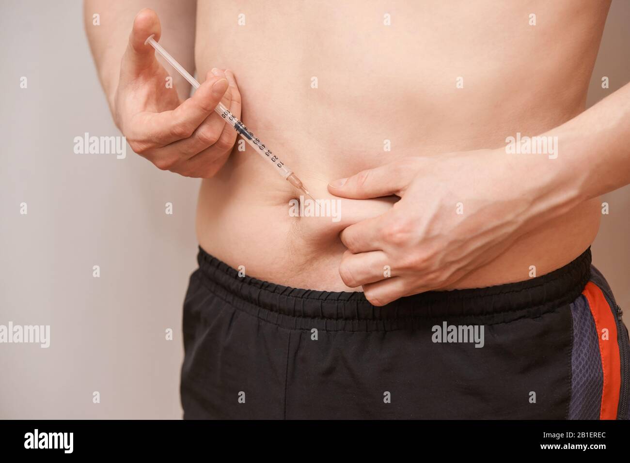 Person injecting stomach medicine treatment. Diabet or hormone male ...