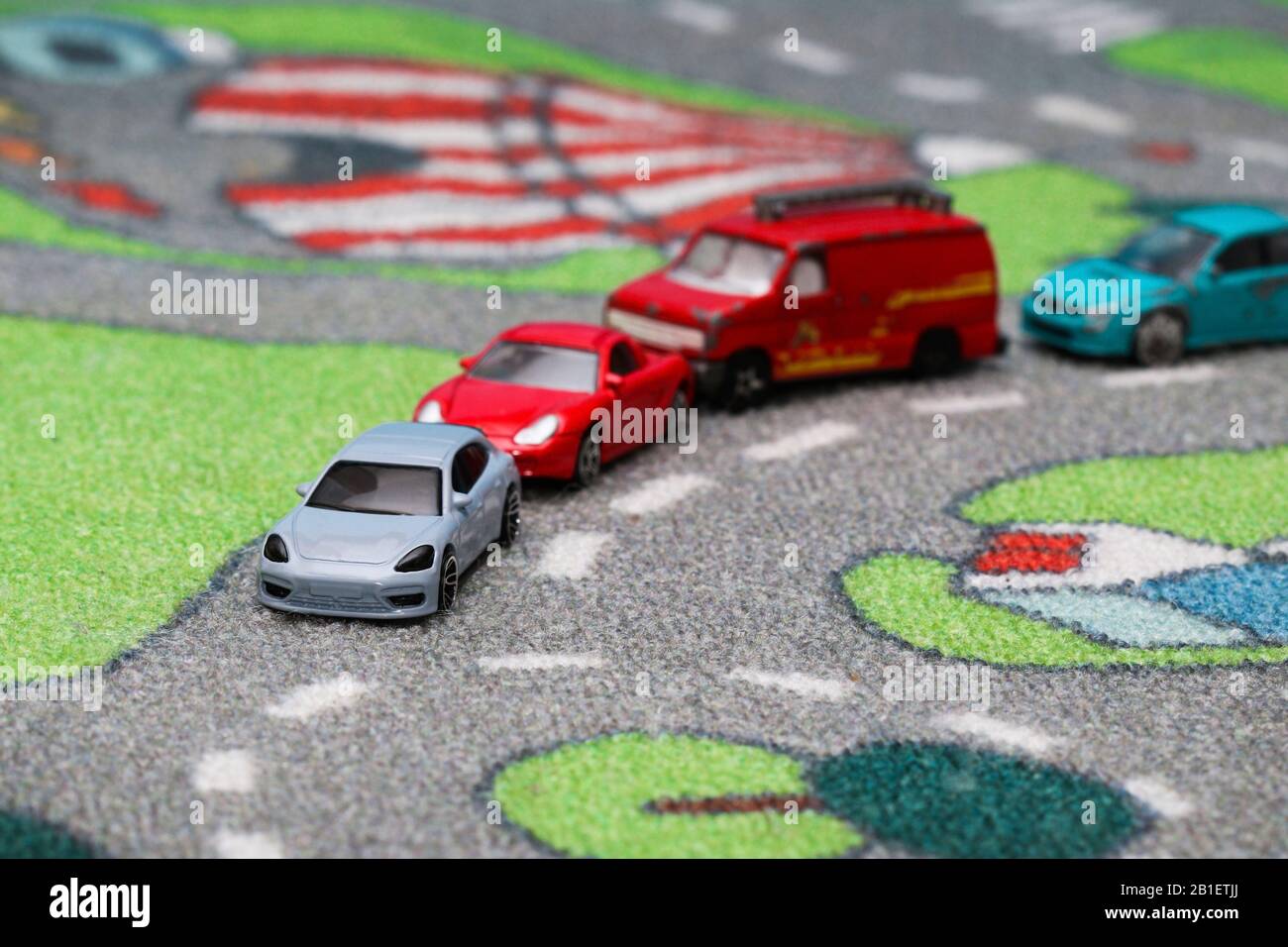 Toy car traffic jam in front of roundabout on car town carpet street Stock Photo