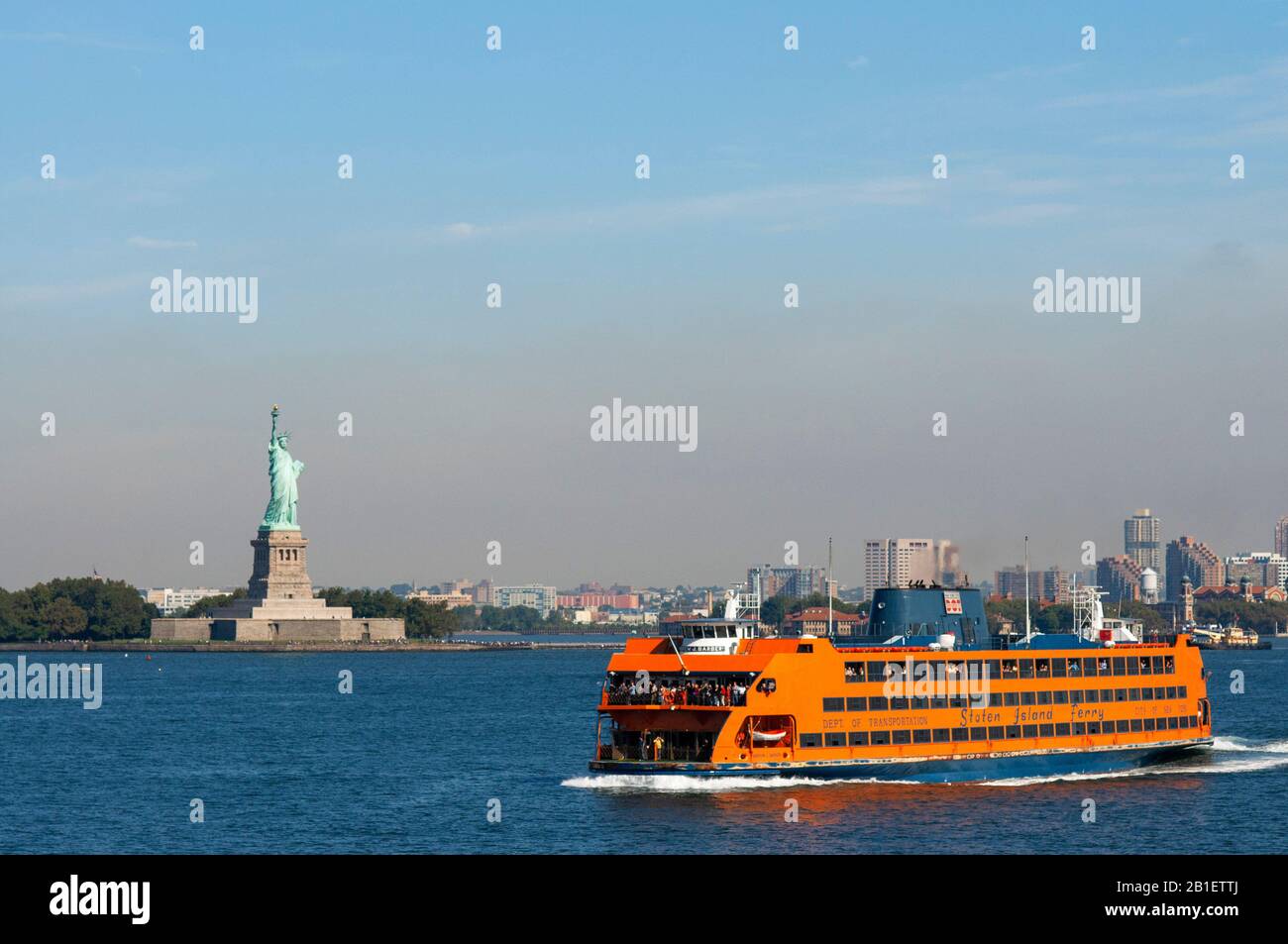 The Staten Island ferry passes the Statue of Liberty , New York City