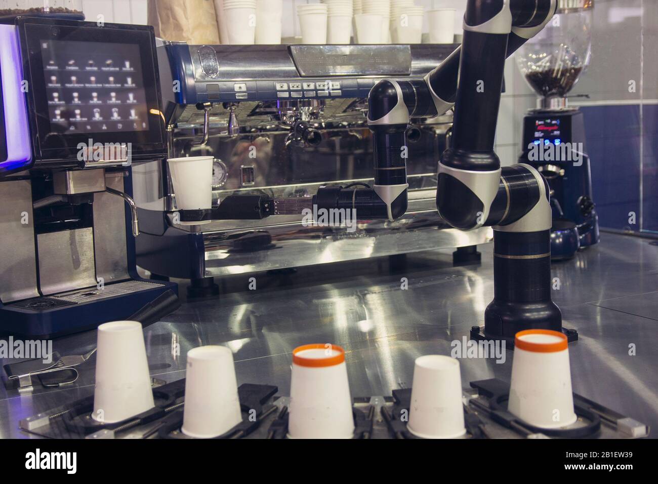Robotic arm preparing coffee in coffee machine Stock Photo