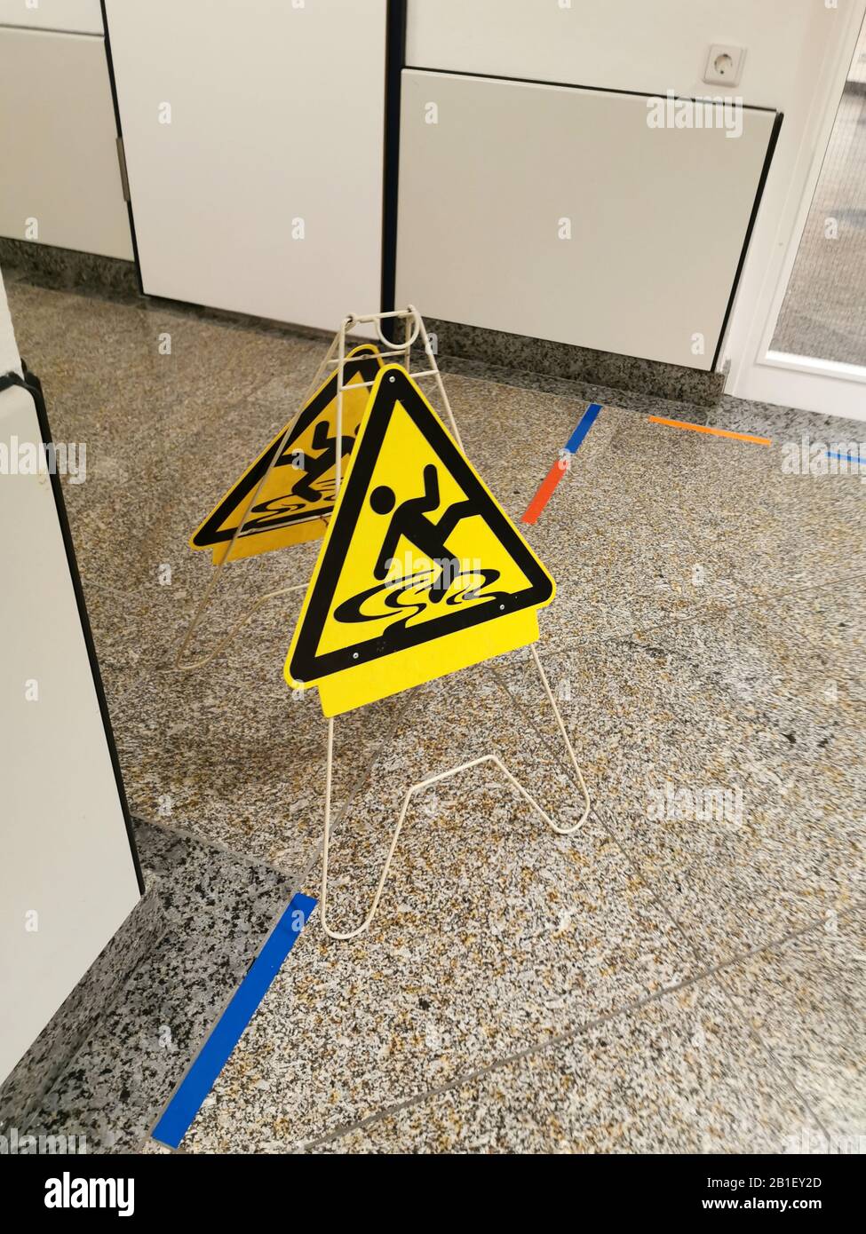 Yellow wet floor warning sign on the floor Stock Photo Alamy