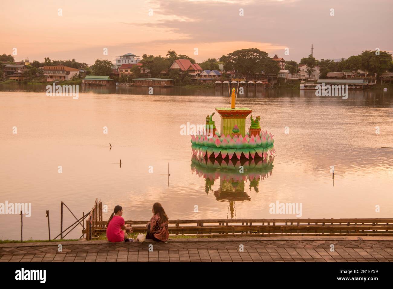 a traditional Krathong at the Loy Krathong festival with the landscape at the Ping River in the evening in the town of Kamphaeng Phet in the Kamphaeng Stock Photo
