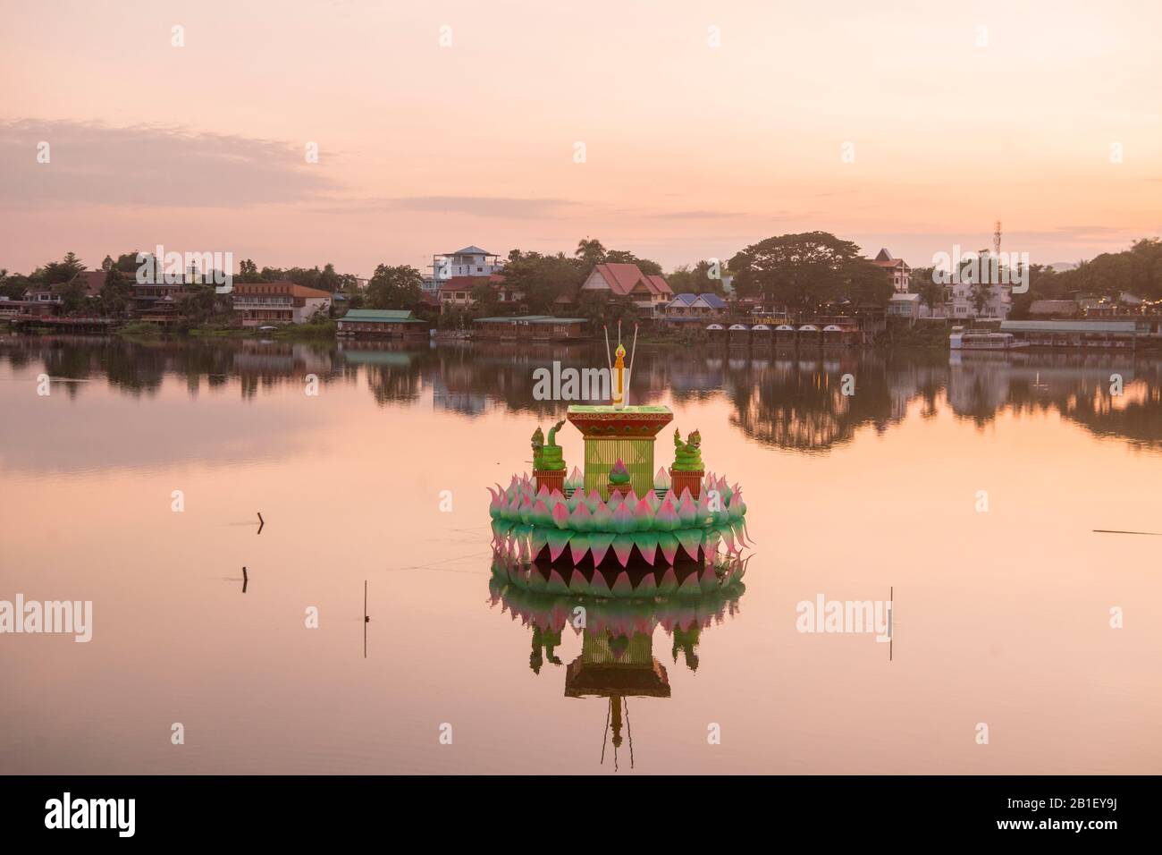 a traditional Krathong at the Loy Krathong festival with the landscape at the Ping River in the evening in the town of Kamphaeng Phet in the Kamphaeng Stock Photo