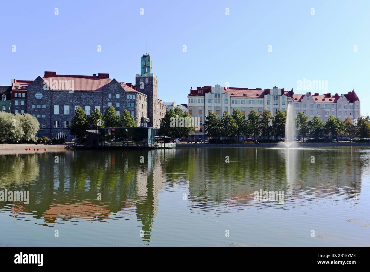 Lake in Helsinki city center with reflection on water, boats station, fountain and sunny blue sky travel Scandinavia Stock Photo