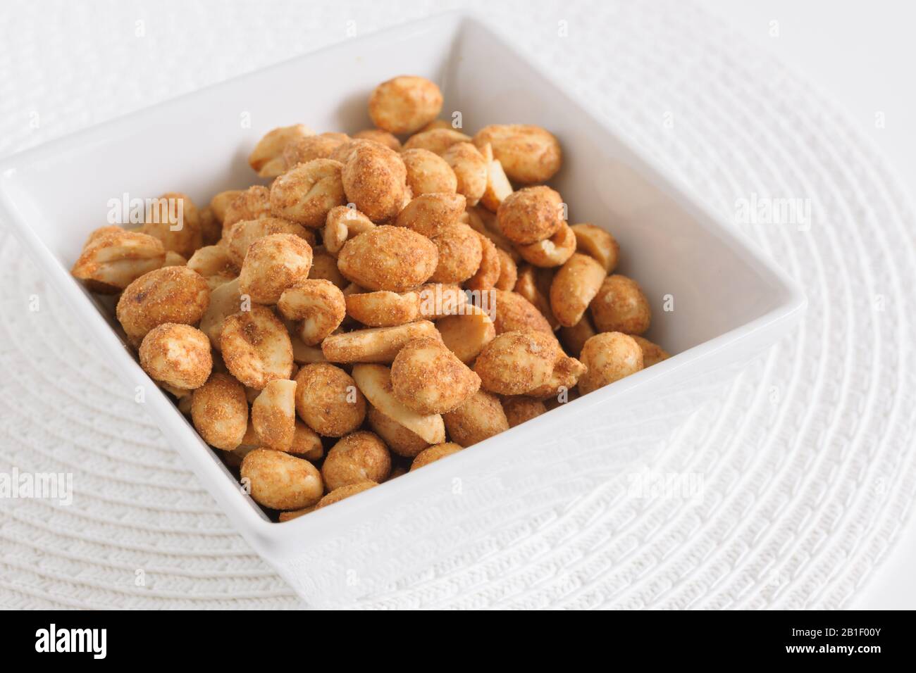 Dry or oven roasted peanuts lightly seasoned eaten as high protein snack Stock Photo