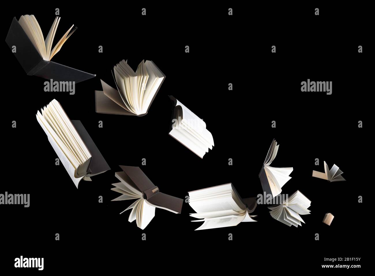 Flying several books isolated on black background. Stock Photo