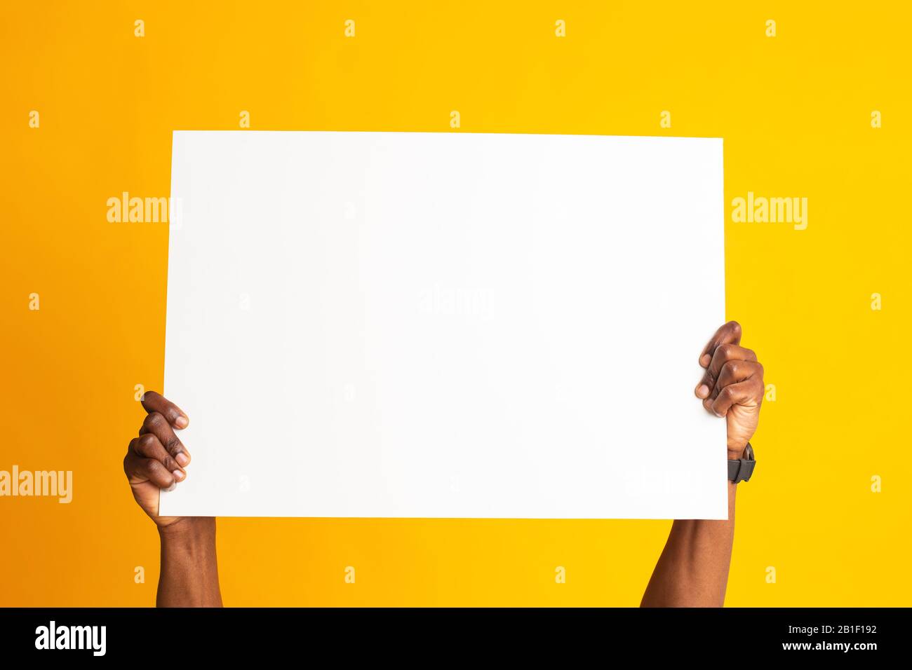 African american hands holding big banner white sheet of paper Stock Photo