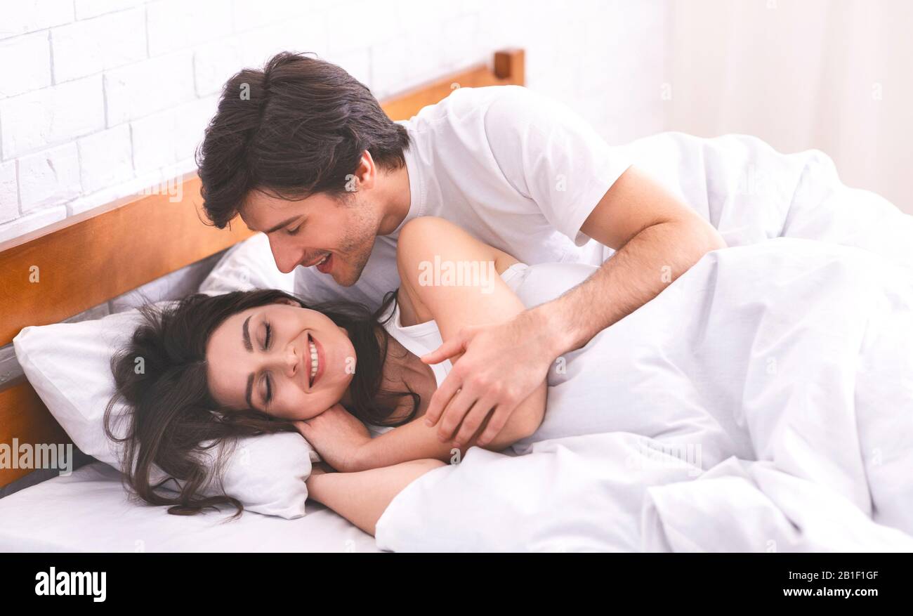 Loving boyfriend kissing his sleeping girlfriend in bed Stock ...