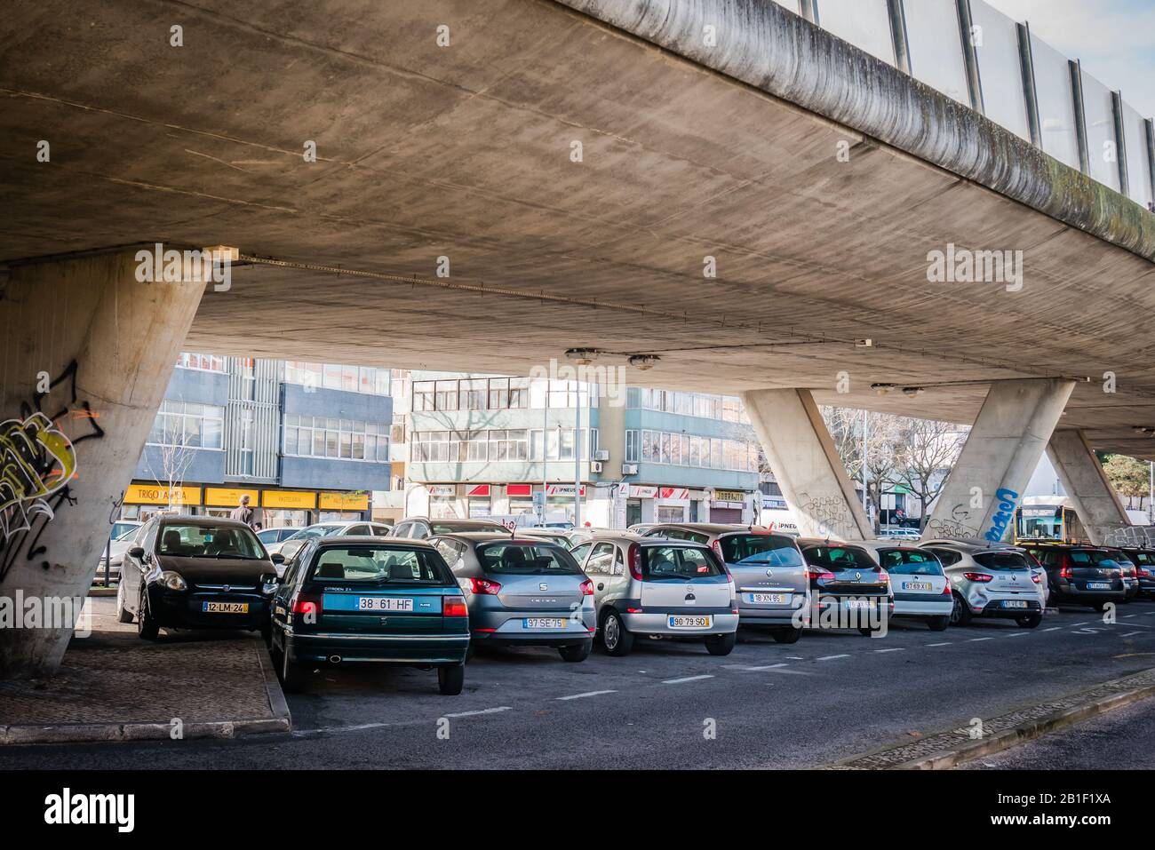 cars parked under a bridge in lisbon portugal Stock Photo