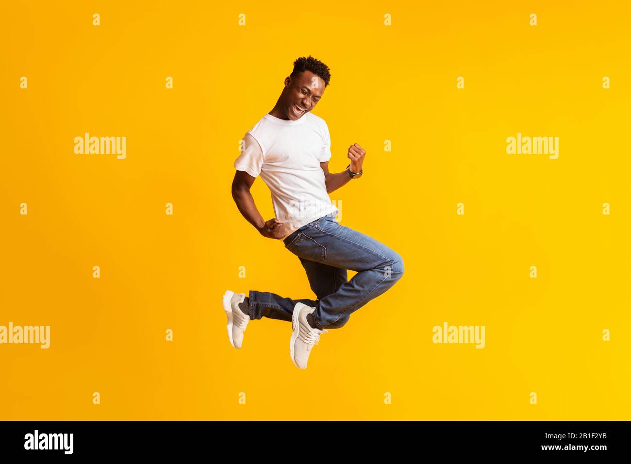 Young black man jumping hi-res stock photography and images - Alamy