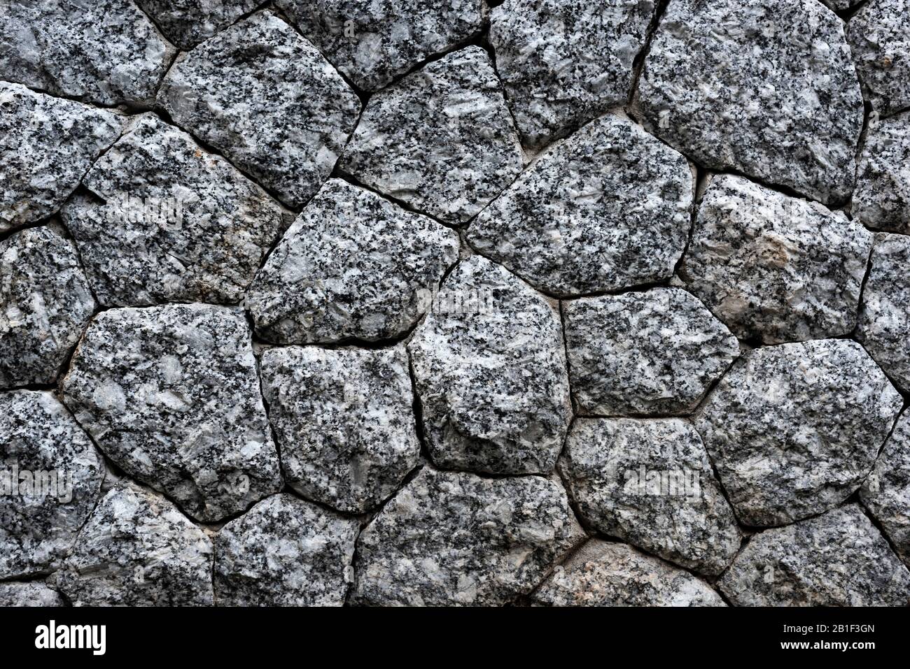 Natural stone masonry wall texture or background Stock Photo
