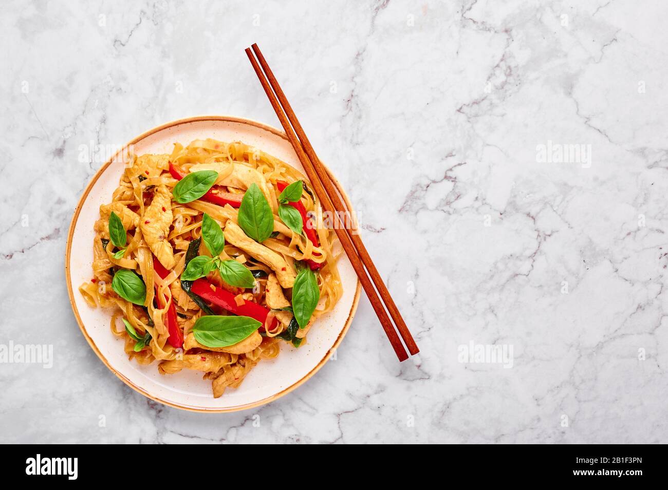 Thai Drunken Noodles or Pad Kee Mao at white marble background. Drunken