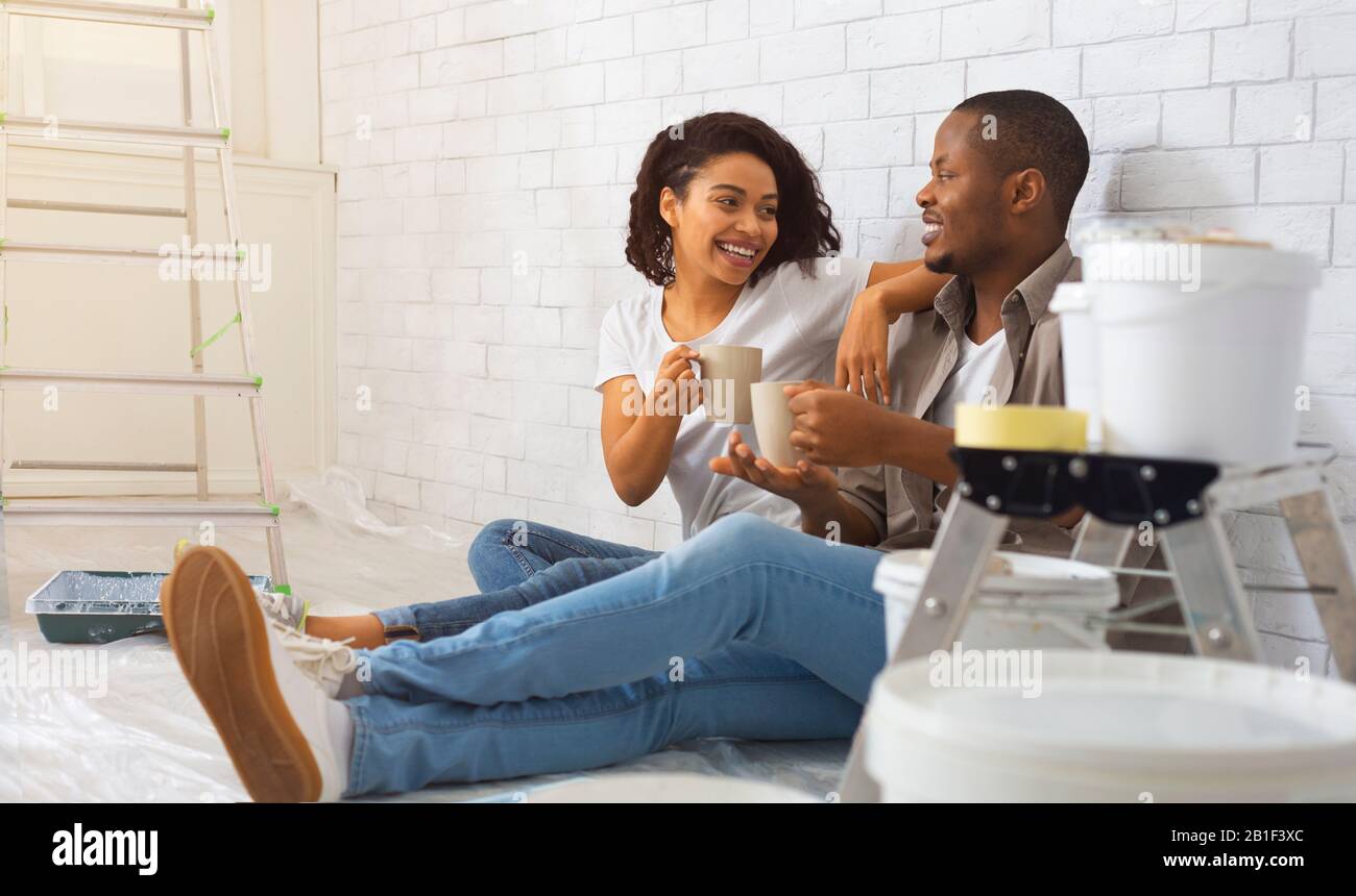 African american young man and woman have a rest from repair Stock Photo