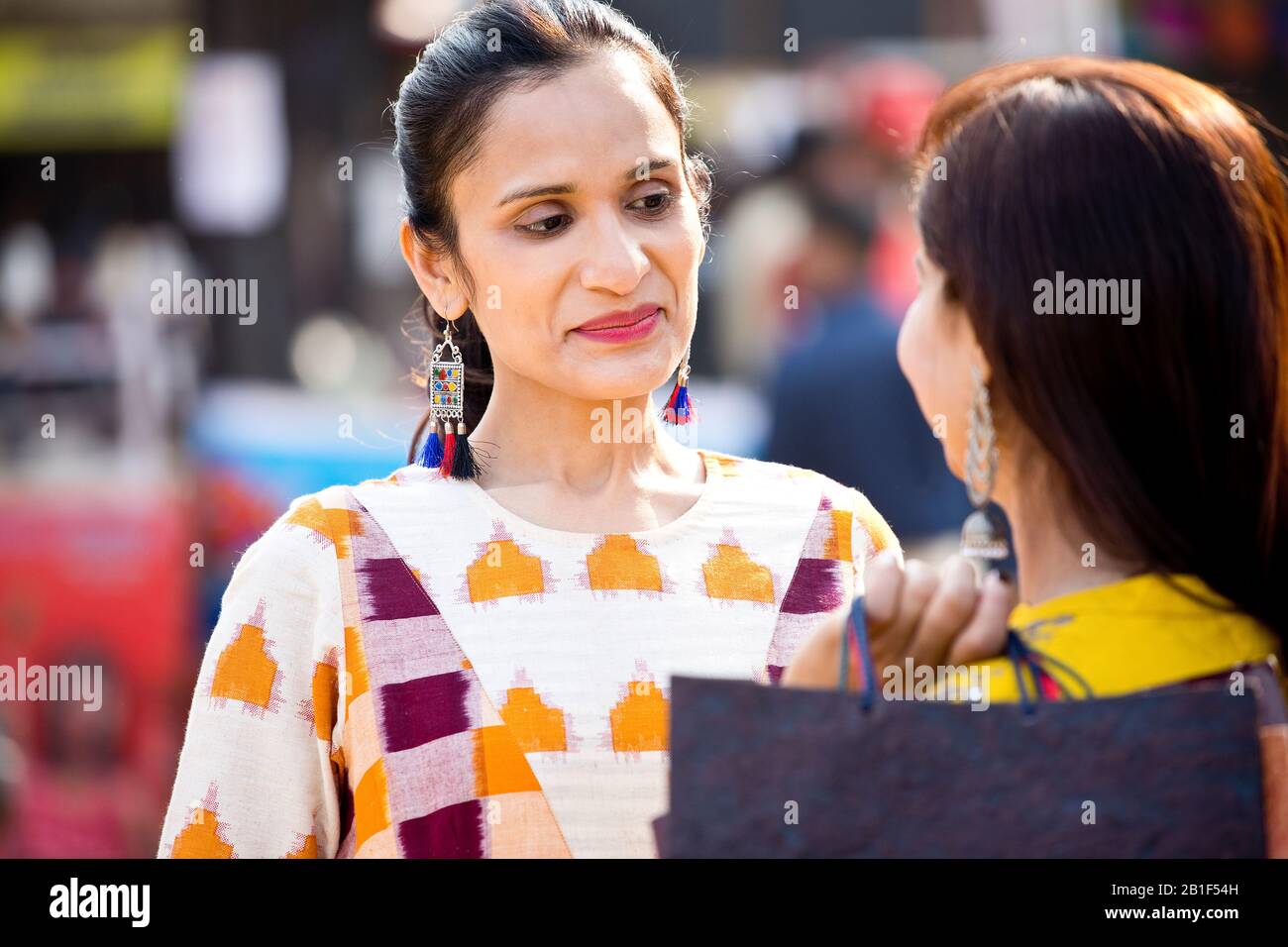 Two women having fun at Surajkund Mela Stock Photo