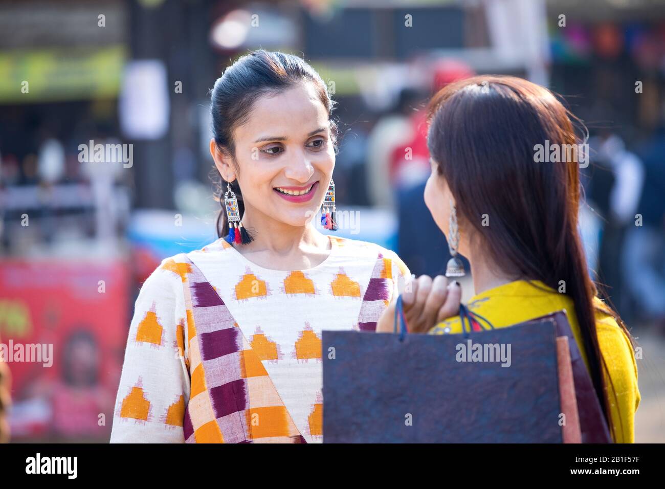 Two women having fun at Surajkund Mela Stock Photo