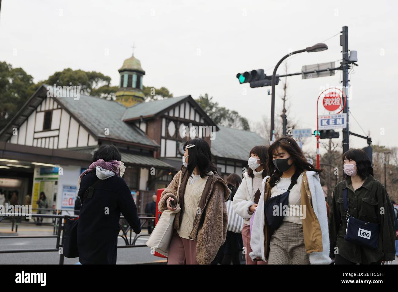 Tokyo, Japan. 25th Feb, 2020. Pedestrians wearing face masks pass by Harajuku Station in Tokyo, Japan, Feb. 25, 2020. TO GO WITH 'Roundup: Japan adopts basic policy to combat novel coronavirus spread' Credit: Du Xiaoyi/Xinhua/Alamy Live News Stock Photo