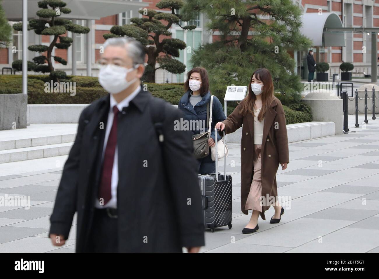 Tokyo, Japan. 25th Feb, 2020. Pedestrians wearing face masks pass by Tokyo Station in Tokyo, Japan, Feb. 25, 2020. TO GO WITH 'Roundup: Japan adopts basic policy to combat novel coronavirus spread' Credit: Du Xiaoyi/Xinhua/Alamy Live News Stock Photo