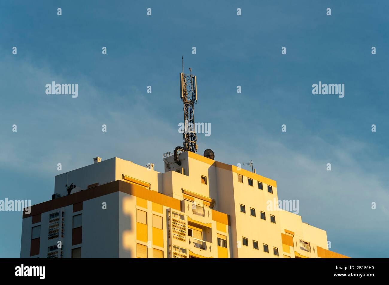 apartment building with a telecommunications mast on the top Stock Photo
