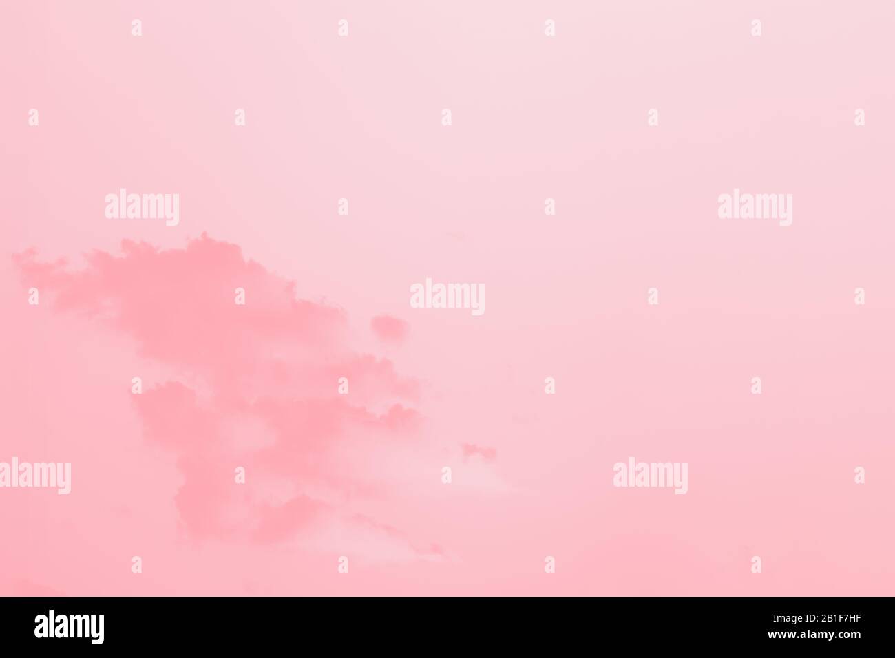 Scenic sky. Beautiful soft fluffy clouds on a clear sky background. Pink coral toned Stock Photo