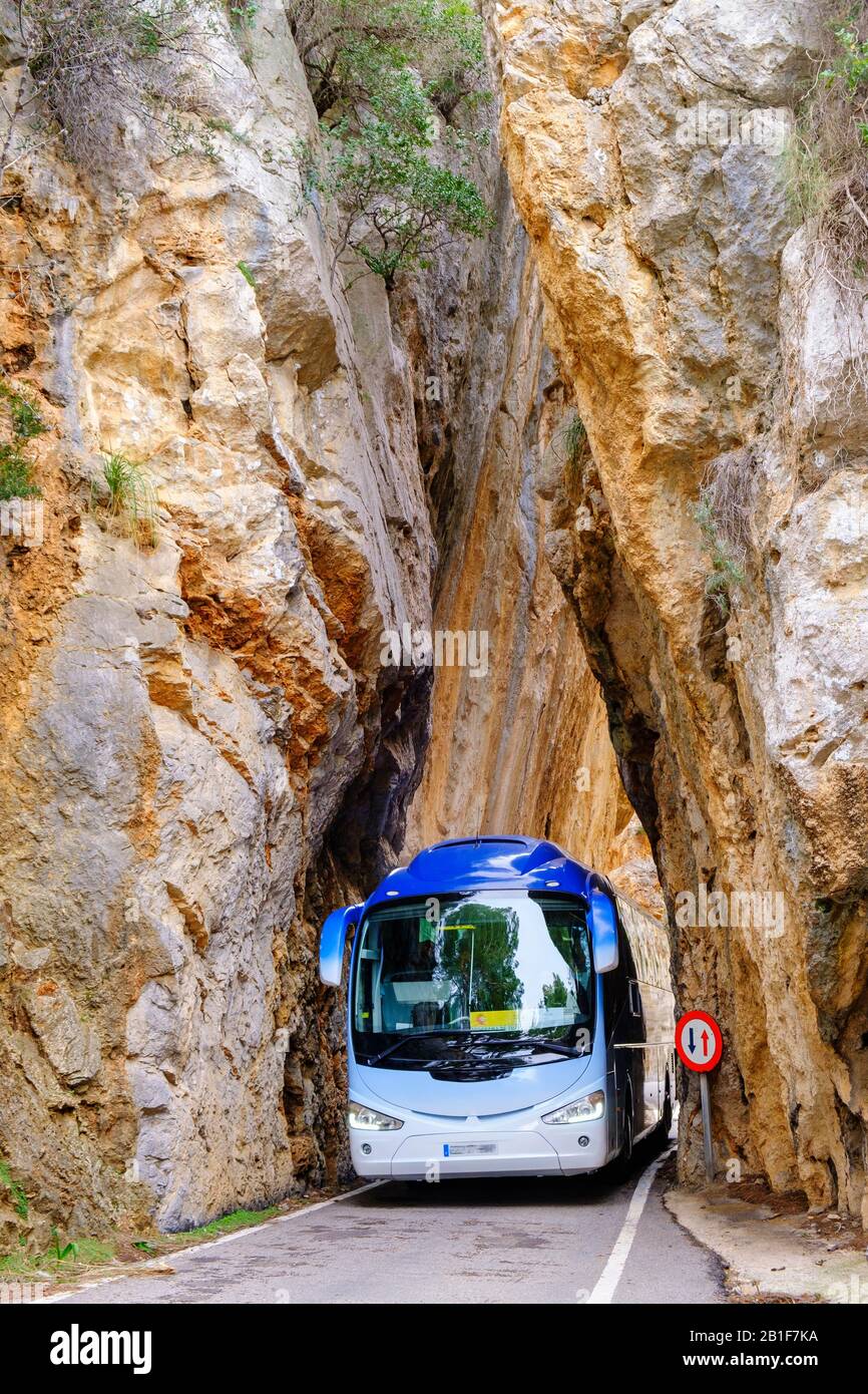 Coach in the rock gate sa Bretxa, mountain road MA-2141, Sa Calobra, Serra de Tramuntana, Majorca, Balearic Islands, Spain Stock Photo