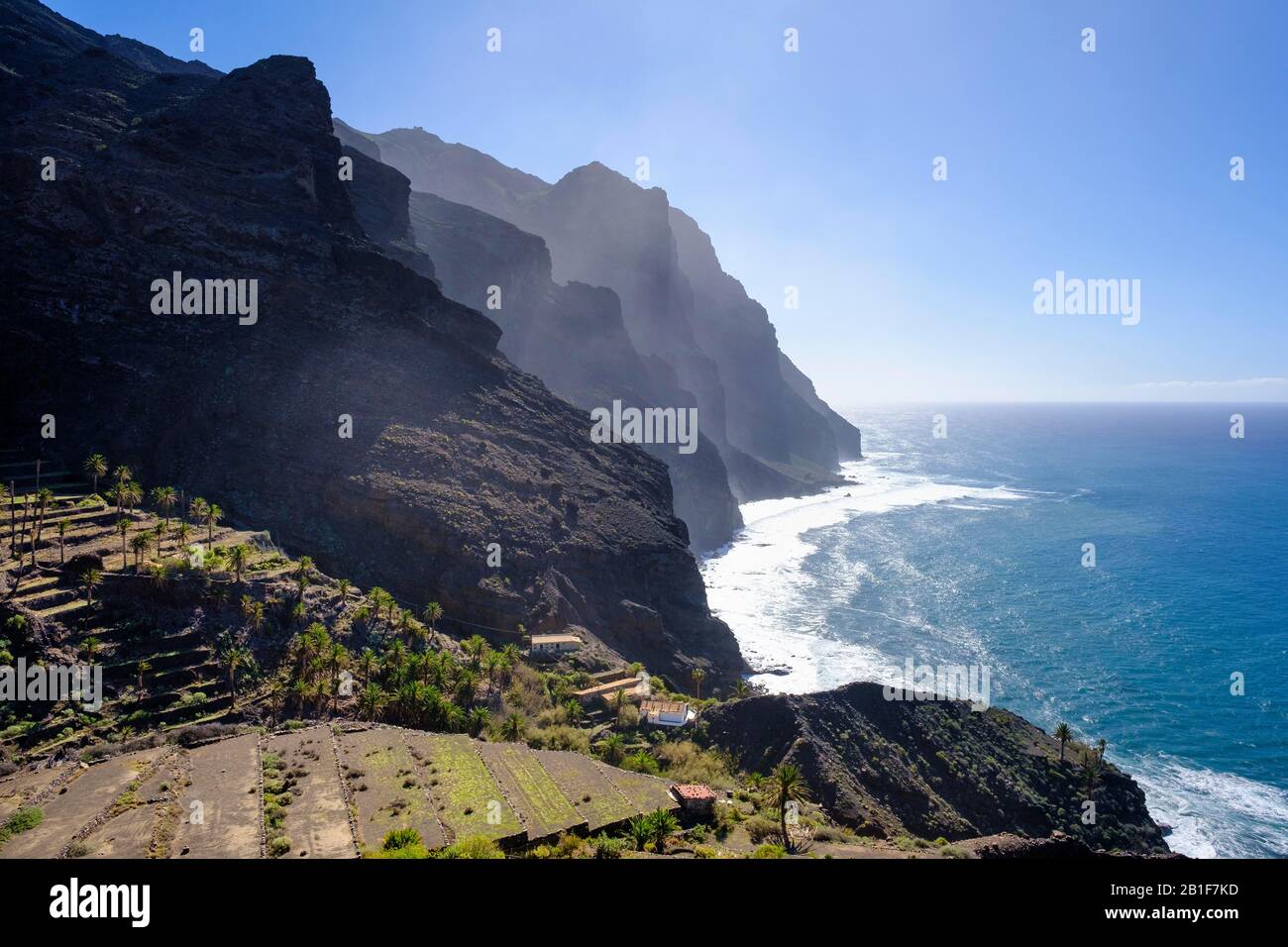 Terraced fields and haze on the rugged coast near Taguluche, La Gomera, Canary Islands, Spain Stock Photo
