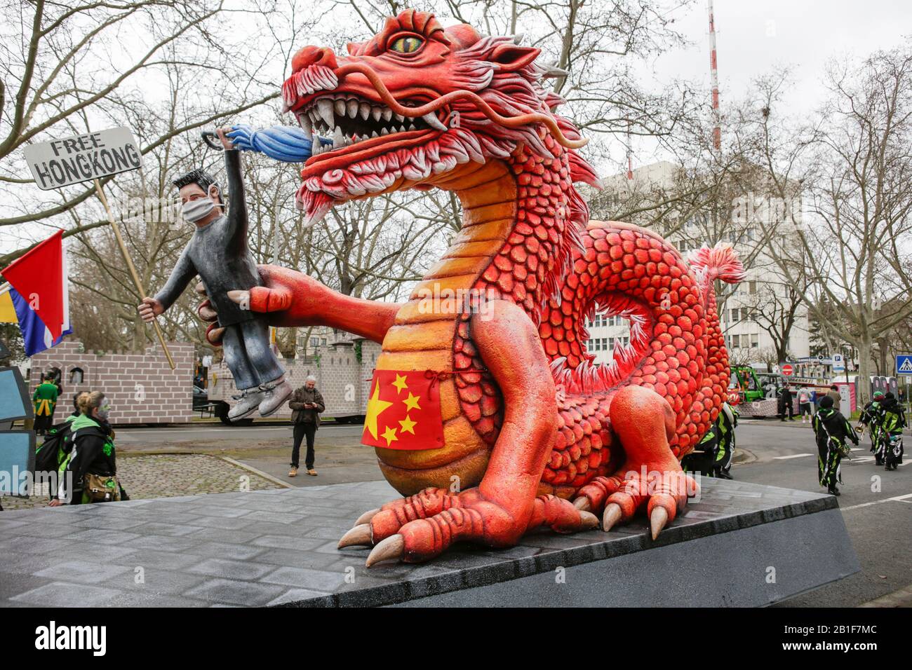 A protester from Hong Kong in the paw of a large red dragon, representing China, is depicted on a float in the Mainz Rose Monday parade. Around half a million people lined the streets of Mainz for the traditional Rose Monday Carnival Parade. The 9 km long parade with over 9,000 participants is one of the three large Rose Monday Parades in Germany. (Photo by Michael Debets/Pacific Press/Sipa USA) Stock Photo