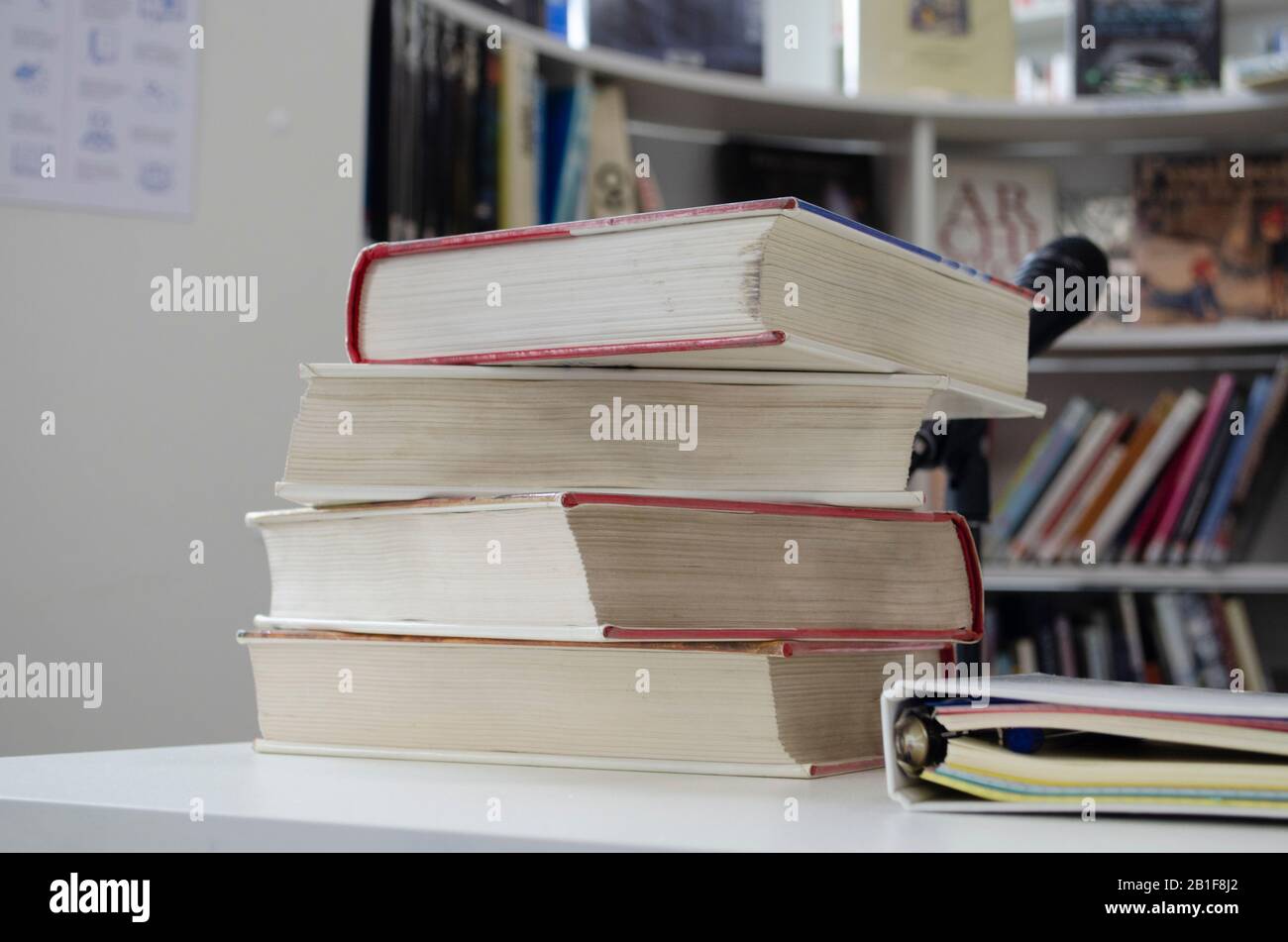 Old dirty books on the table. Books blurred background. Stock Photo