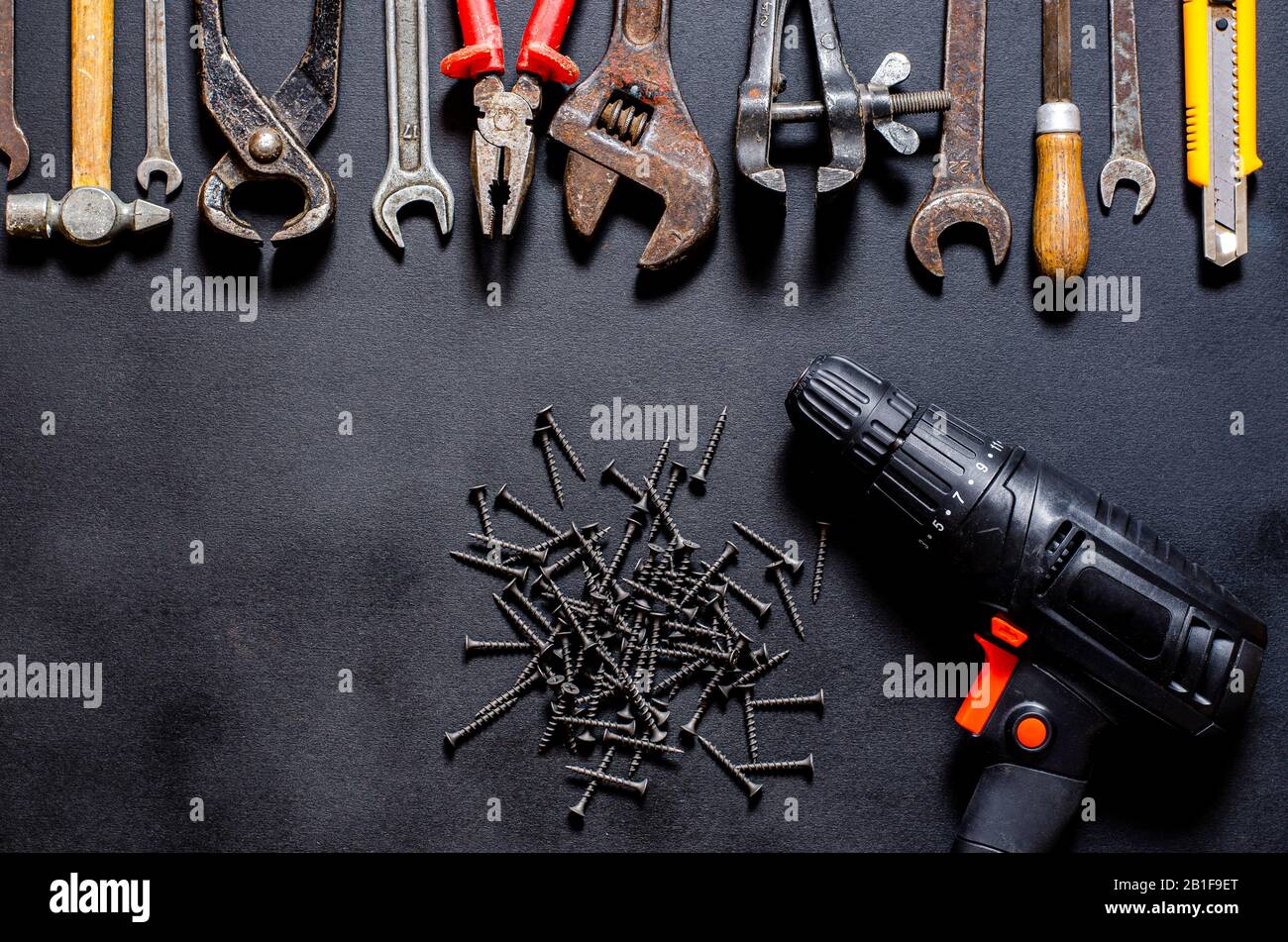 Construction worker tools on a dark background top view. Stock Photo