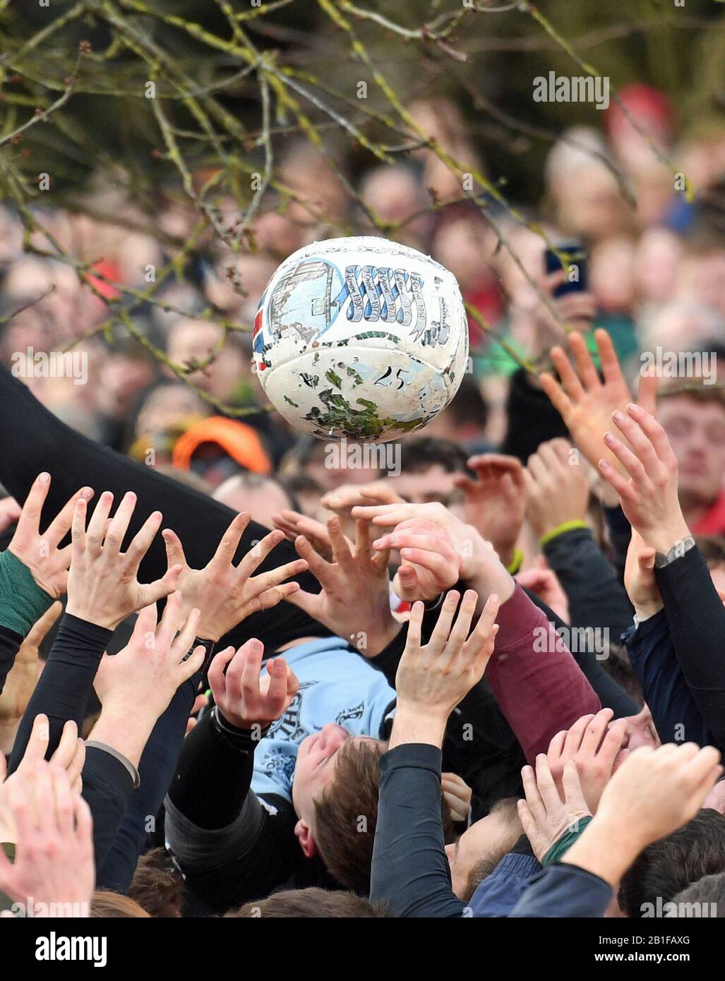 Players take part in the Royal Shrovetide Football Match in Ashbourne, Derbyshire, which has been played in the town since the 12th century. Stock Photo