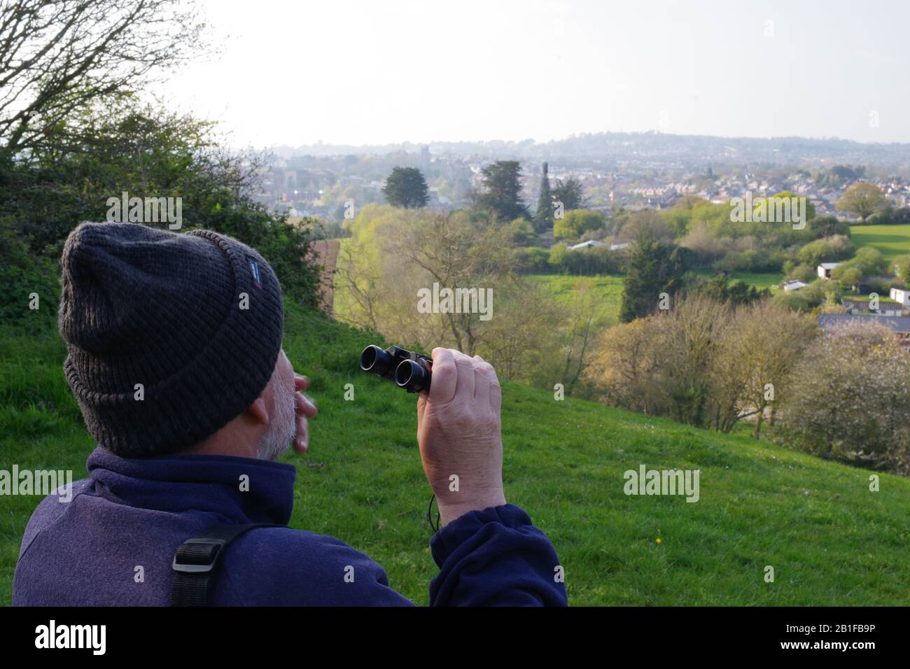 Birdwatcher with Binoculars with Spring Farming View. Ludwell Valley